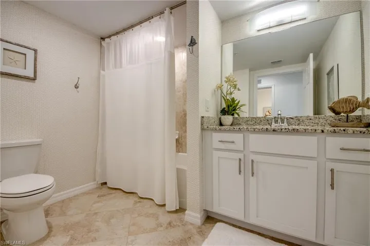 Full bathroom with vanity, toilet, and shower / tub combo