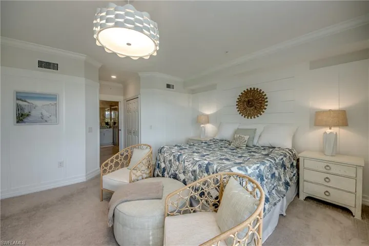 Bedroom featuring light carpet, a closet, and crown molding