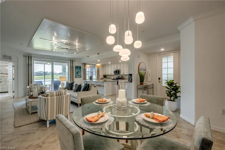 Dining room featuring crown molding and an inviting chandelier