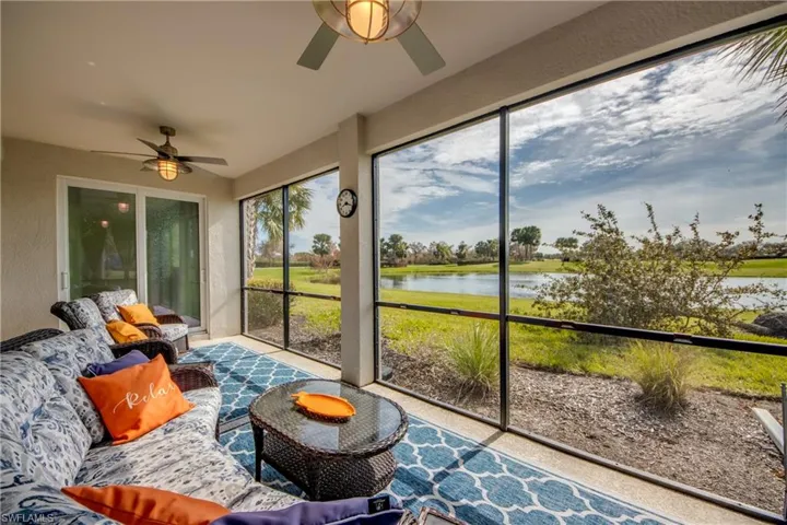 Sunroom / solarium with a water view and ceiling fan