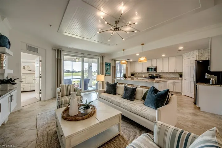 Living room featuring a notable chandelier and light tile patterned flooring