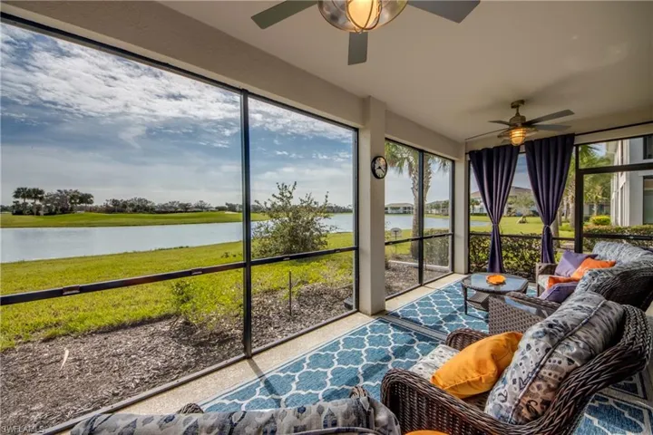 Sunroom with a water view and ceiling fan
