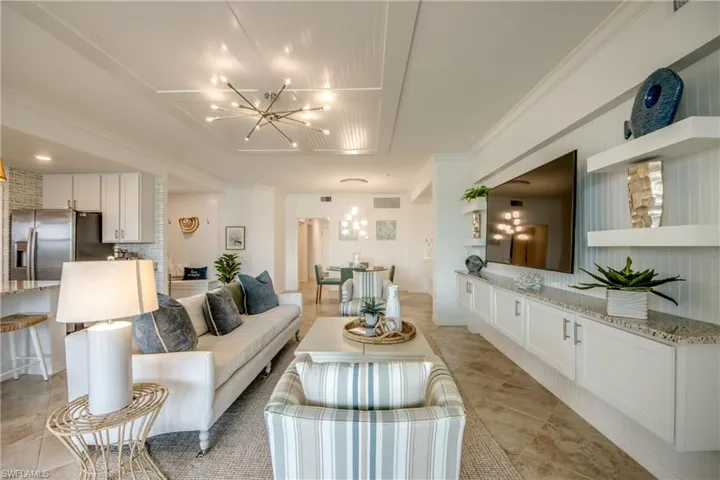 Living room featuring a chandelier and crown molding