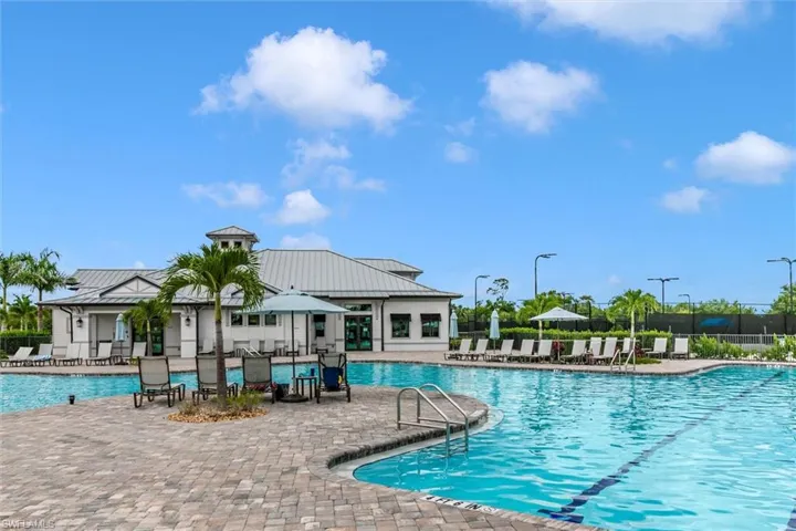 View of community swimming pool with a patio area