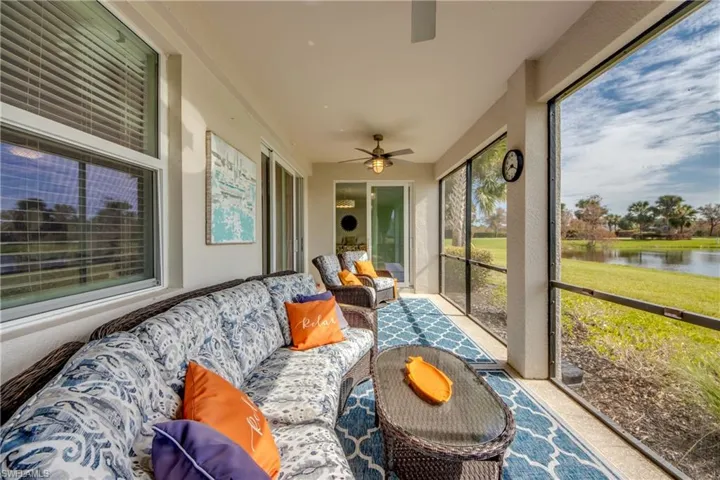 Sunroom / solarium with a water view and ceiling fan