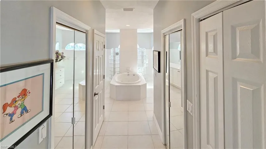 Corridor with light tile patterned flooring