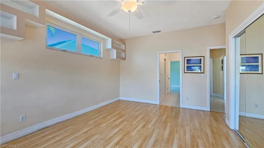 Empty room featuring light hardwood / wood-style flooring and ceiling fan