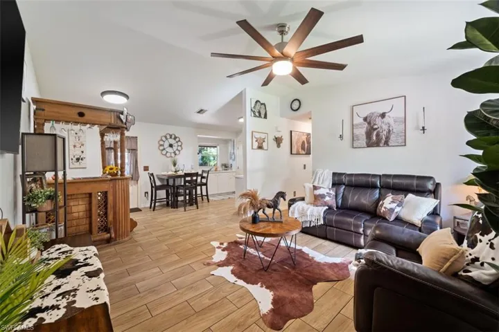Living area with wood finish floors and lofted ceiling