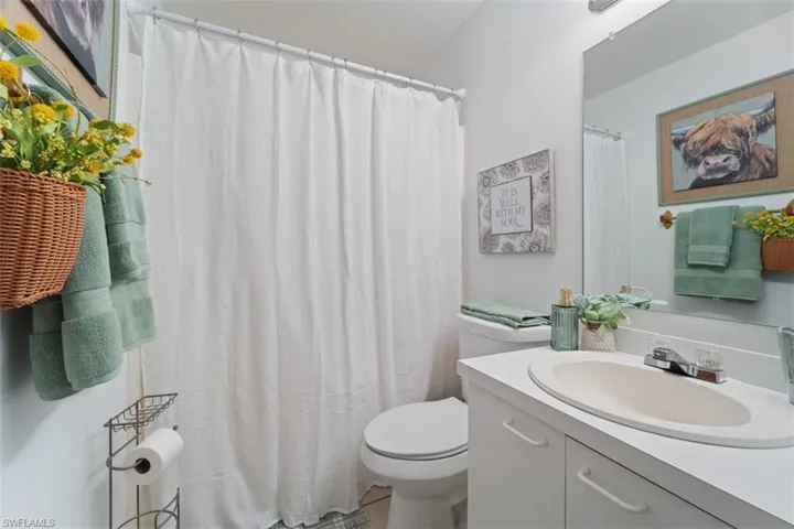 Full bath with vanity and a shower with curtain