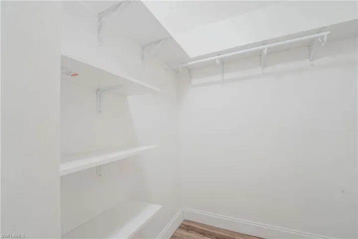 Spacious closet with wood finished floors