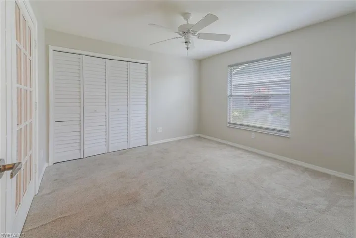 Unfurnished bedroom with a closet, carpet floors, and baseboards