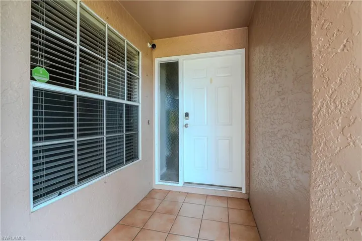 View of exterior entry with stucco siding