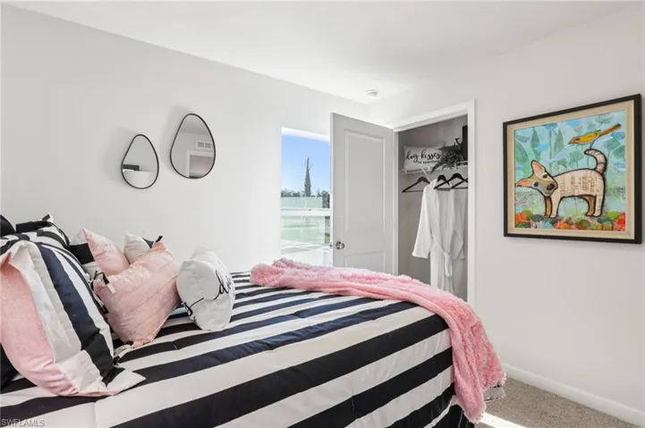 Model home. Bedroom featuring carpet flooring and baseboards
