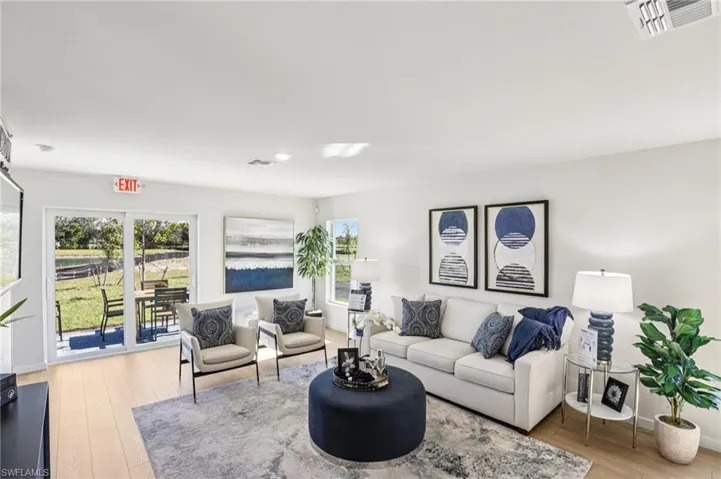 Model home. Living area featuring light wood-style floors and baseboards