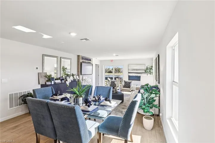 Model home. Dining area with light wood finished floors and baseboards