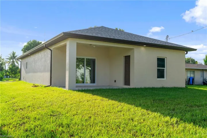 Back of house featuring a yard