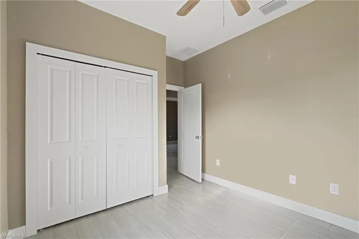 Unfurnished bedroom with a closet and ceiling fan