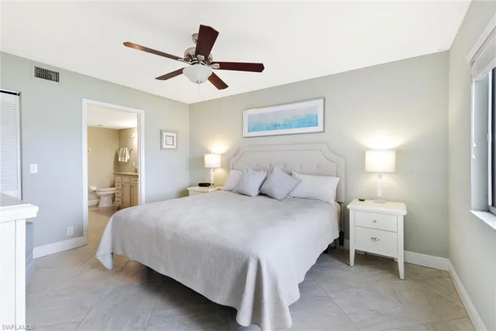 Bedroom featuring ceiling fan and ensuite bathroom
