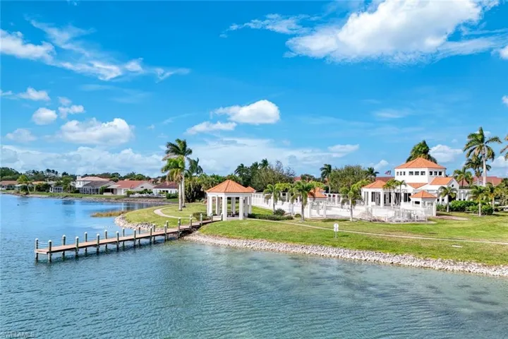 Water view featuring a dock and nearby suburban area