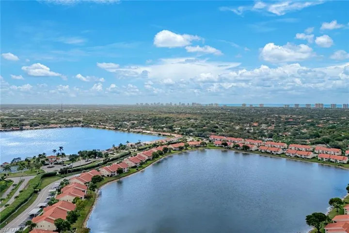 Drone / aerial view of a nearby body of water and skyline