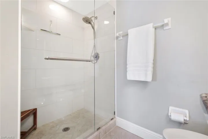 Luxurious frameless glass shower and updated floor to ceiling tile