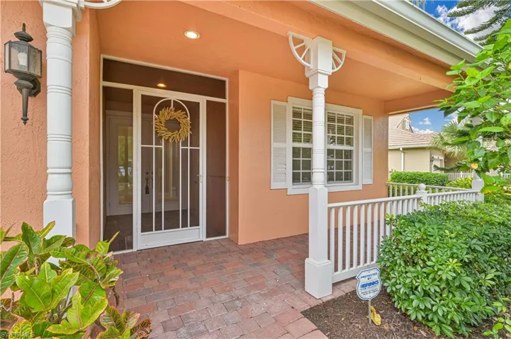 View of exterior entry with a porch