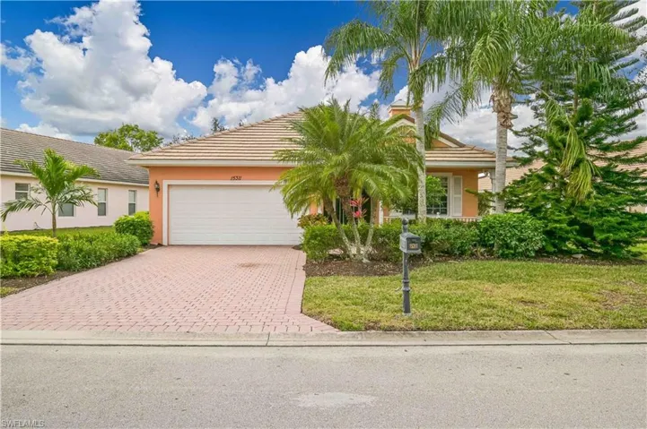 View of front facade with a garage and a front lawn