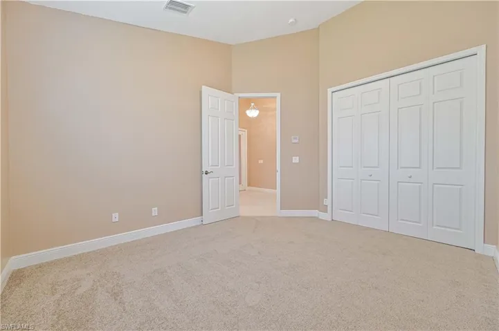 Unfurnished bedroom featuring carpet flooring and a closet