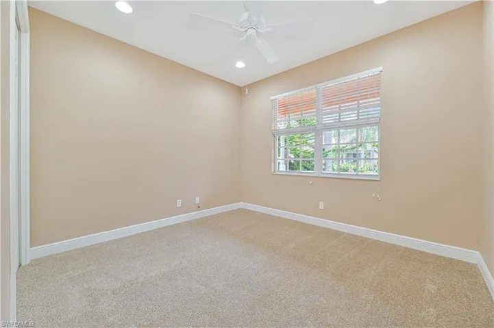 Empty room with carpet and ceiling fan