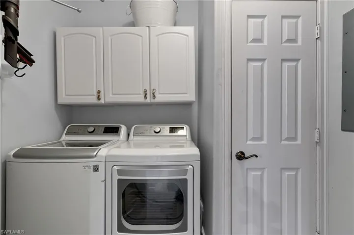 Laundry room with cabinet storage.