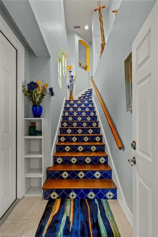 Hardwood and tile stairs from entry to living space.