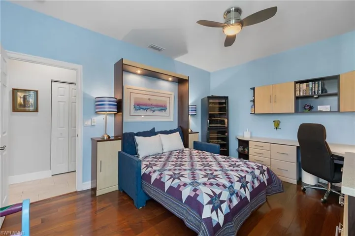 Guest bedroom with built in cabinets and Murphy bed that folds into a couch.