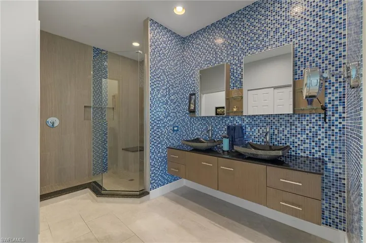 Updated primary bathroom with dual sinks and walk in shower.