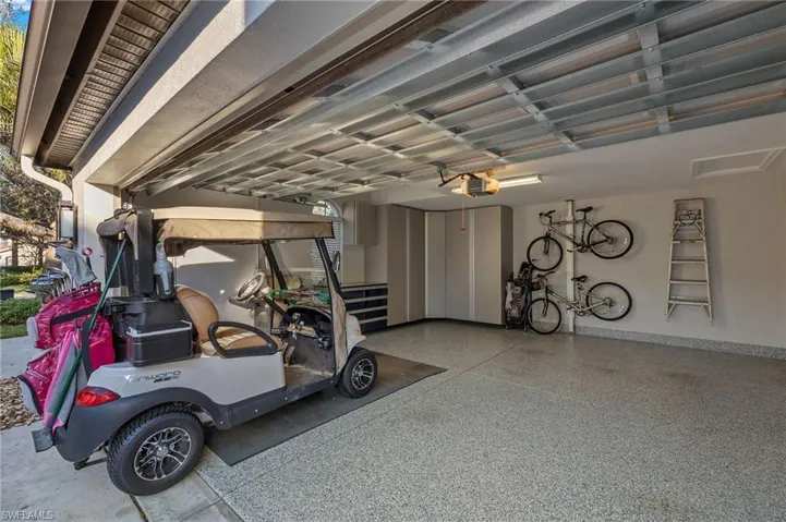 Two car garage with epoxy floor and custom cabinets.