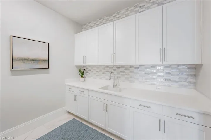 Large laundry room with plenty of cabinet space