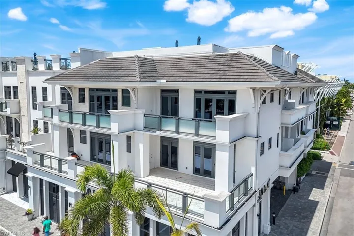 Front of building showing the large third floor balconies for this unit