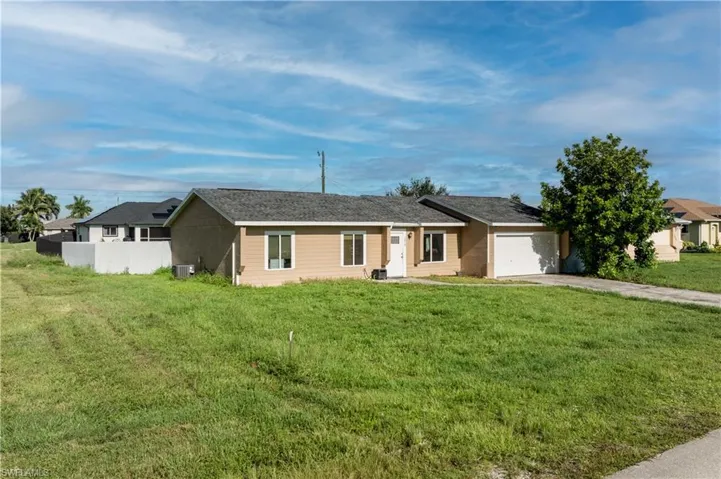 Single story home with a garage and concrete driveway