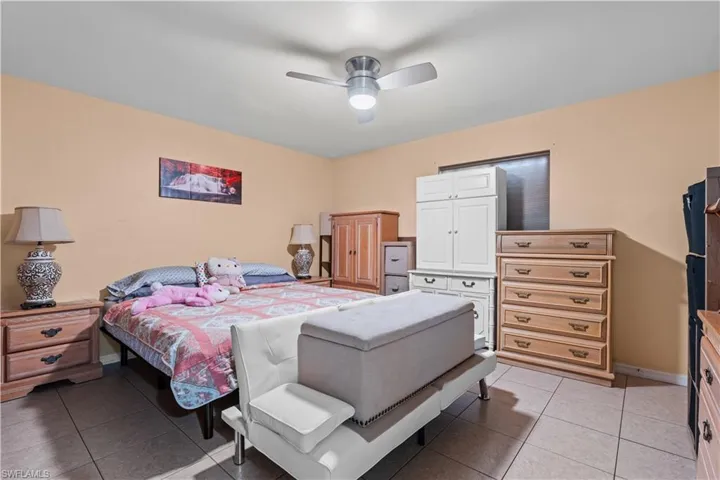Bedroom featuring light tile patterned floors and ceiling fan