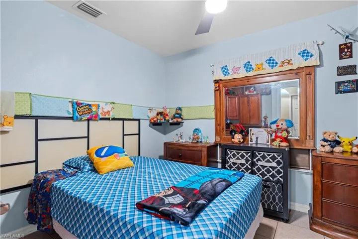 Bedroom with tile patterned flooring and ceiling fan