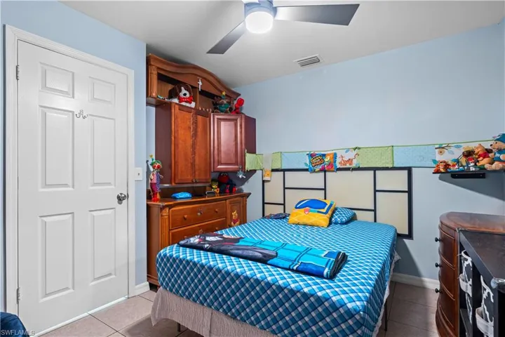 Bedroom featuring light tile patterned floors and a ceiling fan