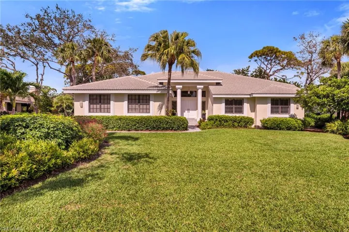 Great curb appeal with side entry garage and long driveway, lush landscaping