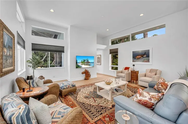 Love all the windows that allows natural light in! The porcelain wood-style flooring is throughout the home except for guest bedrooms.