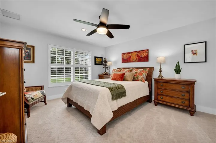 Guest bedroom with new carpet, plantation shutters, and plenty of space.