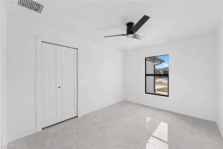 Unfurnished bedroom featuring ceiling fan and a closet