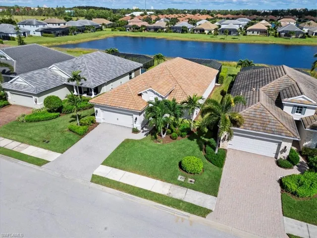 Birds eye view of property with a water view