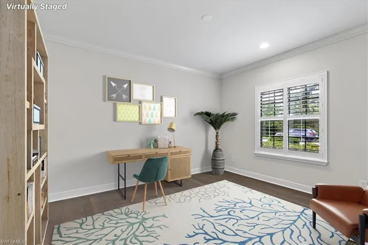 Office area with ornamental molding and dark wood-type flooring