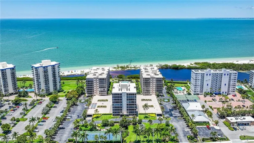 Aerial view featuring a beach view and a water view