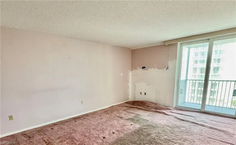 Spare room featuring carpet flooring and a textured ceiling