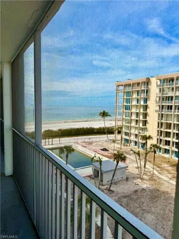 Balcony with a view of the beach and a water view