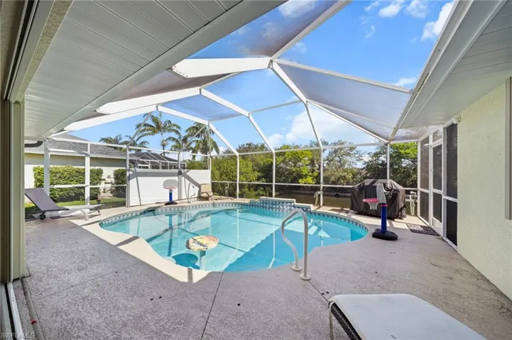 Outdoor pool with a patio area, a lanai, and a sunroom